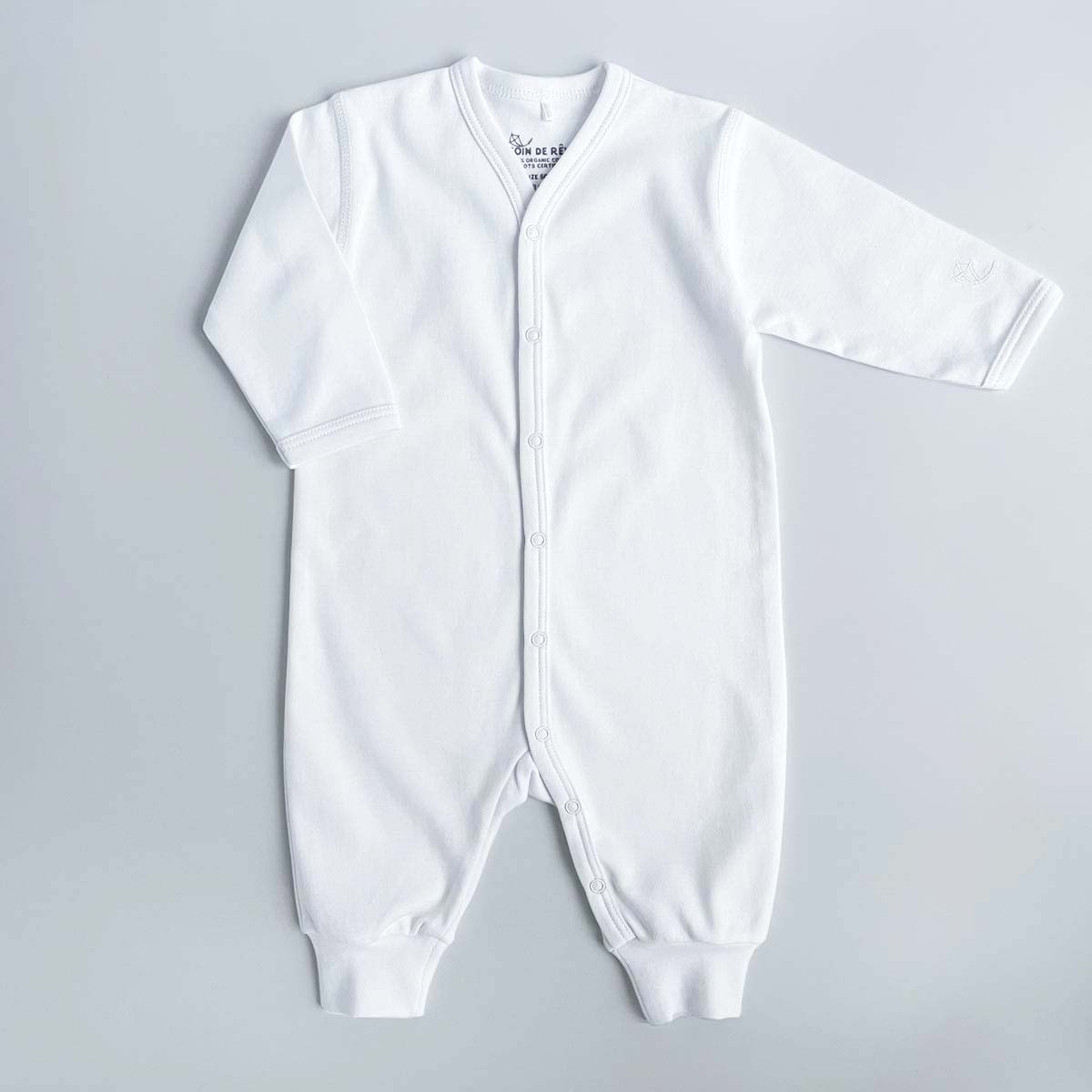 Vit jumpsuit för baby i ekologisk pimabomull