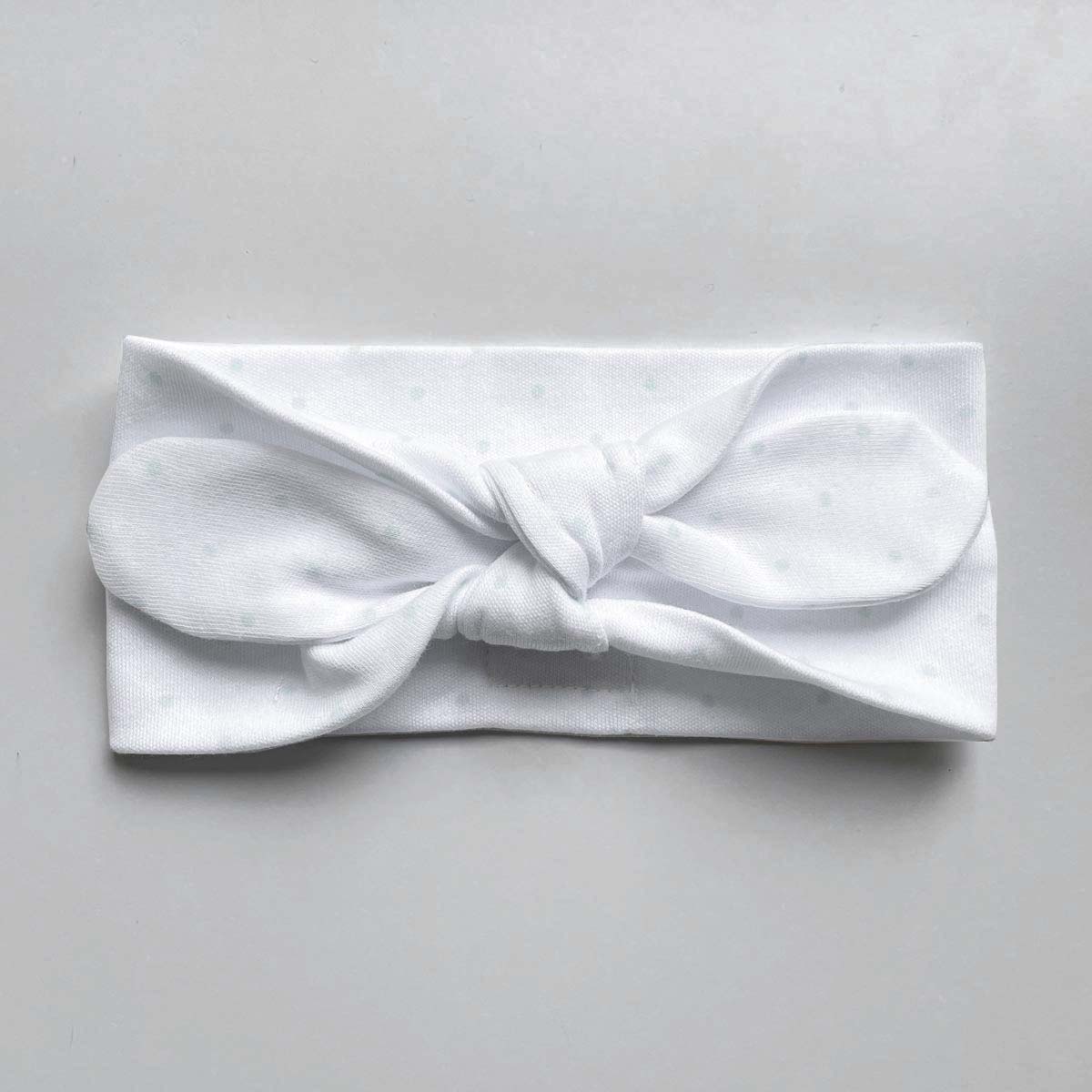 Vitt hårband med mintfärgade prickar för baby i ekologisk bomull med knut fram